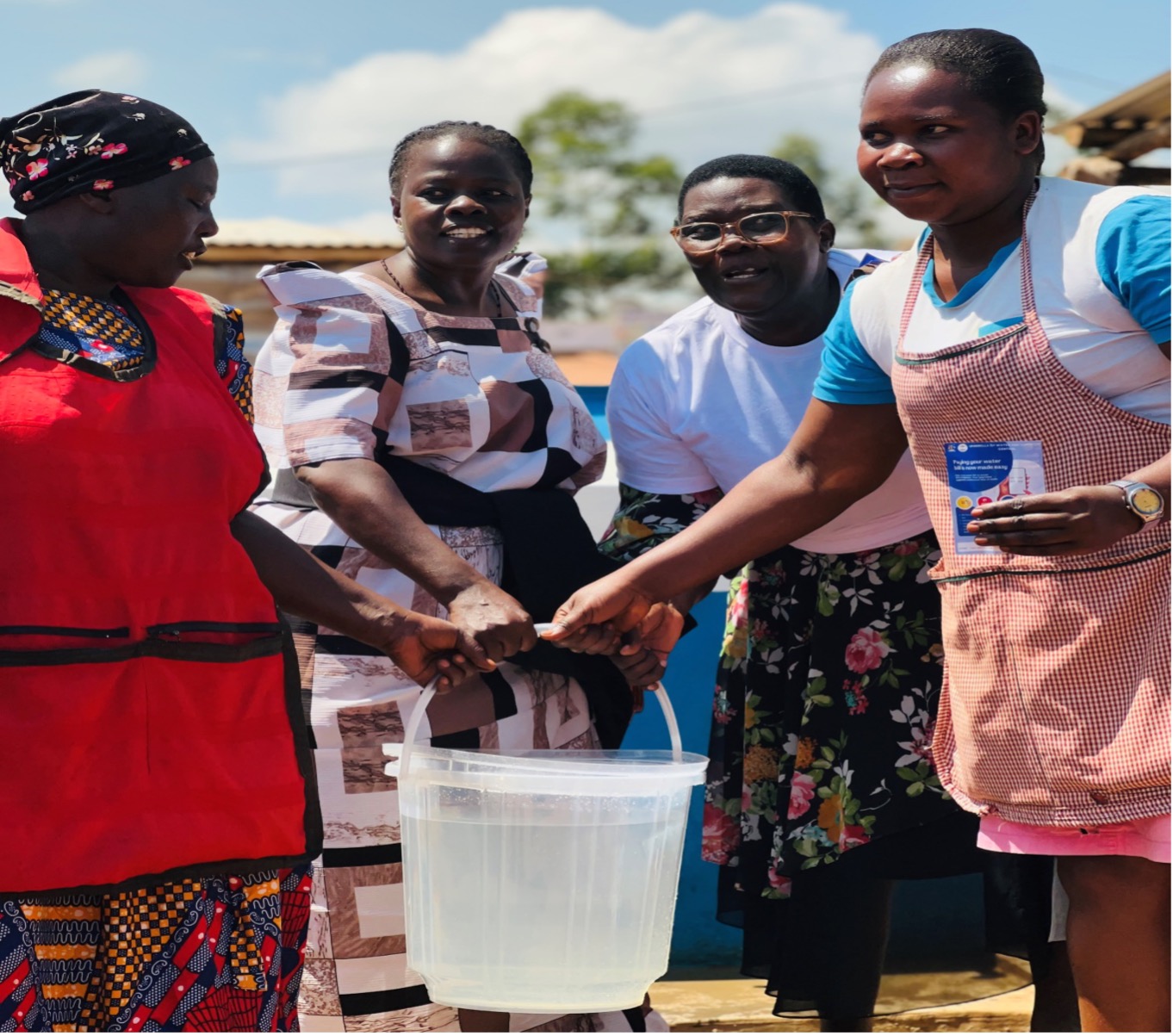 The Resident District Commissioner (3rd from right) handing over a completed system to beneficiaries.