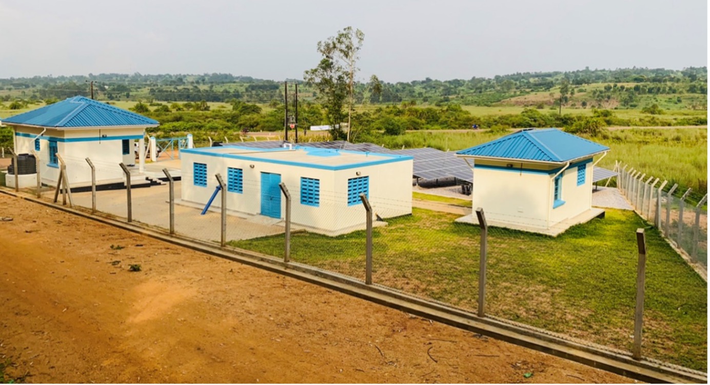 An overview of the pump house, operator house, collection tank and solar panels on Butenga-Kawoko Piped Water Supply System.