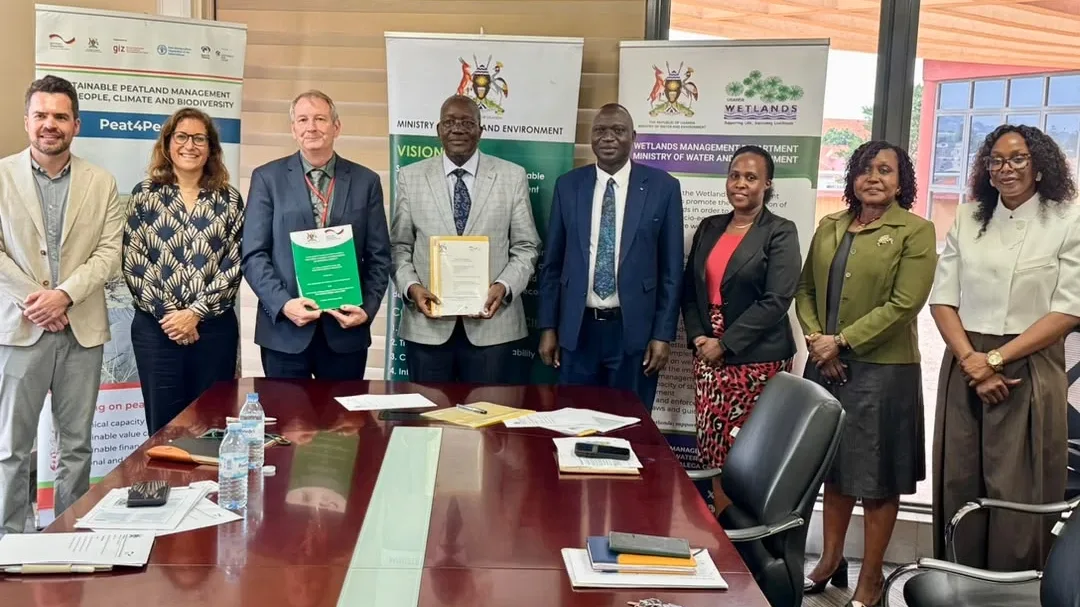 MWE, PS Dr. Alfred Okot Okidi and the Country Director of GIZ, Mr. James Macbeth Forbes with other staff after MOU signing.