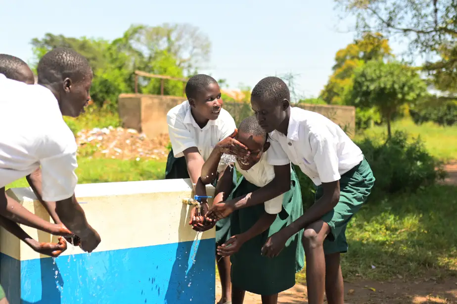 Kapir primary school pupils enjoy a sip of clean drinking water